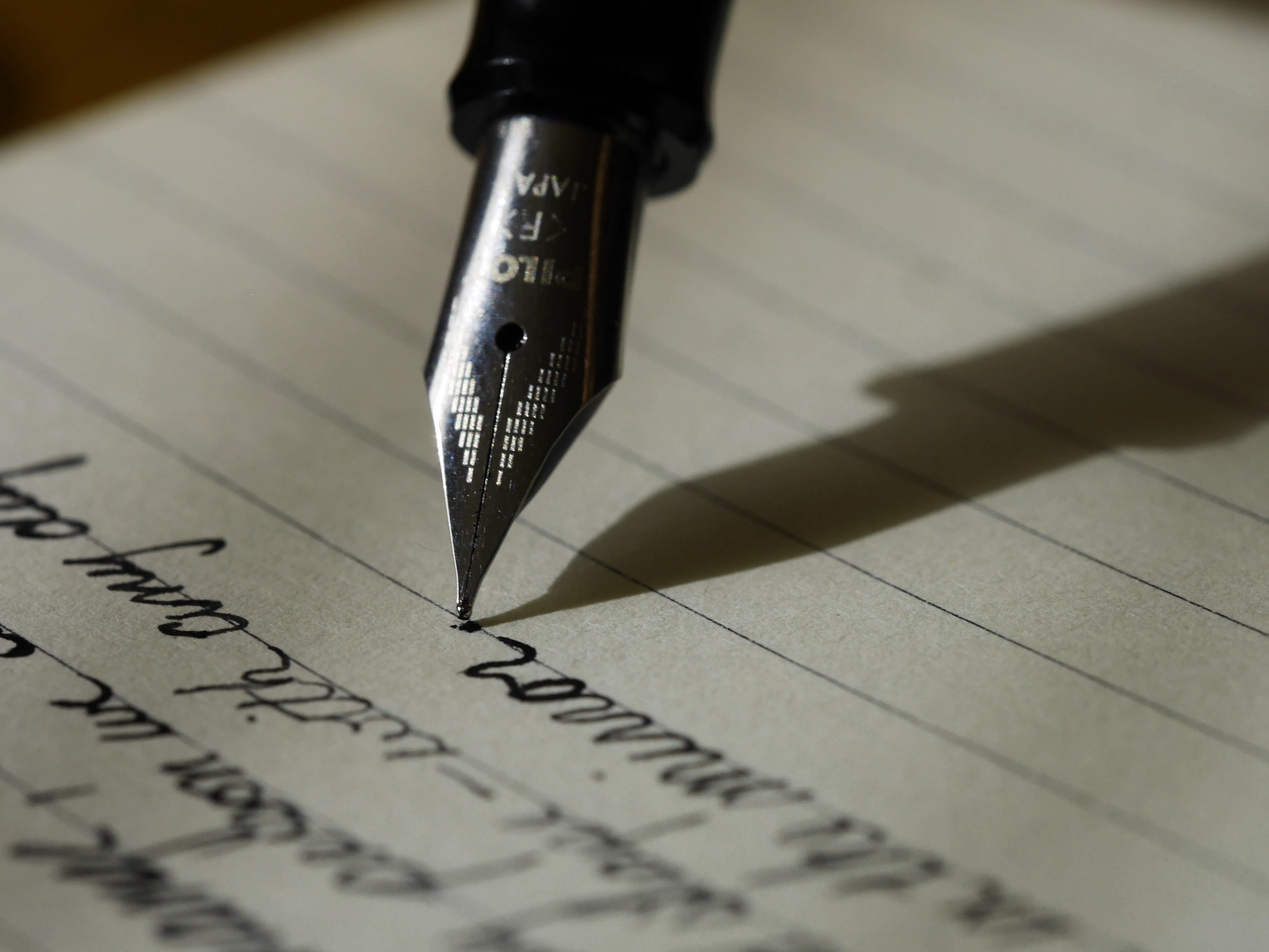 A pen writing on a page